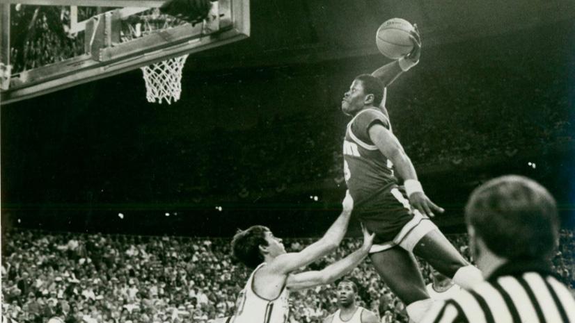 Georgetown's Patrick Ewing dunks over a Kentucky defender.