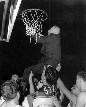 Everett Case cuts down the net with NC State